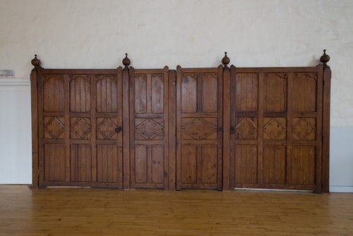 The pitch pine stall dividers fold back into the wall
